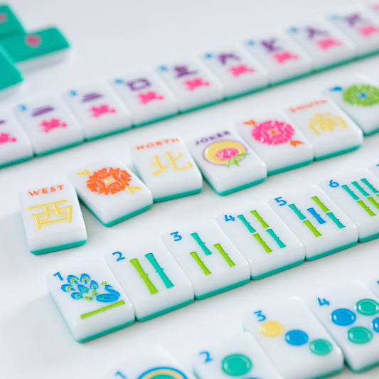 Collection of colorful Mahjong tiles on a white background