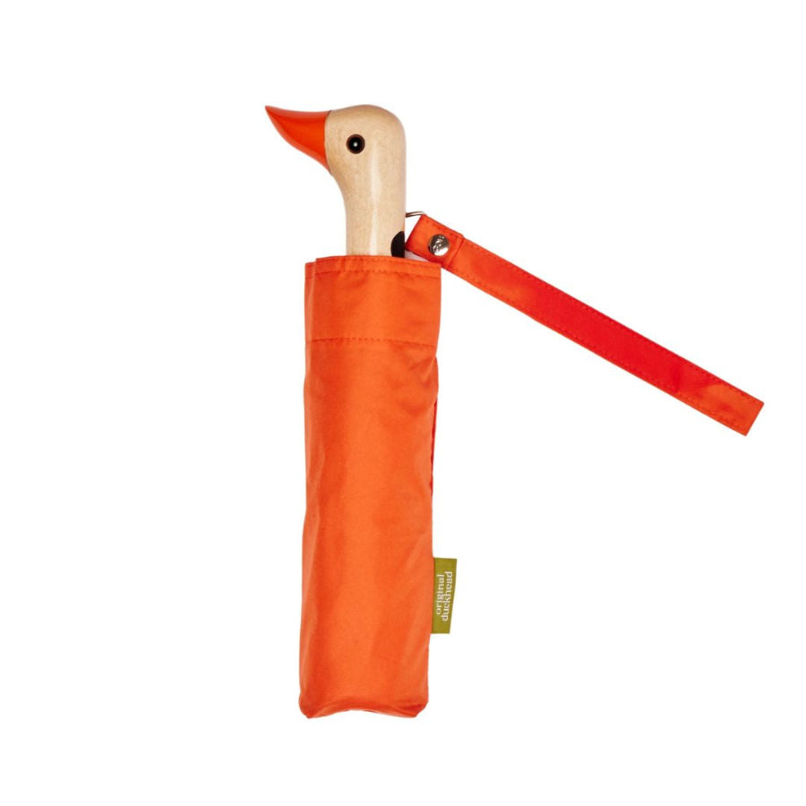 Orange duck-shaped umbrella with a wooden handle on a white background