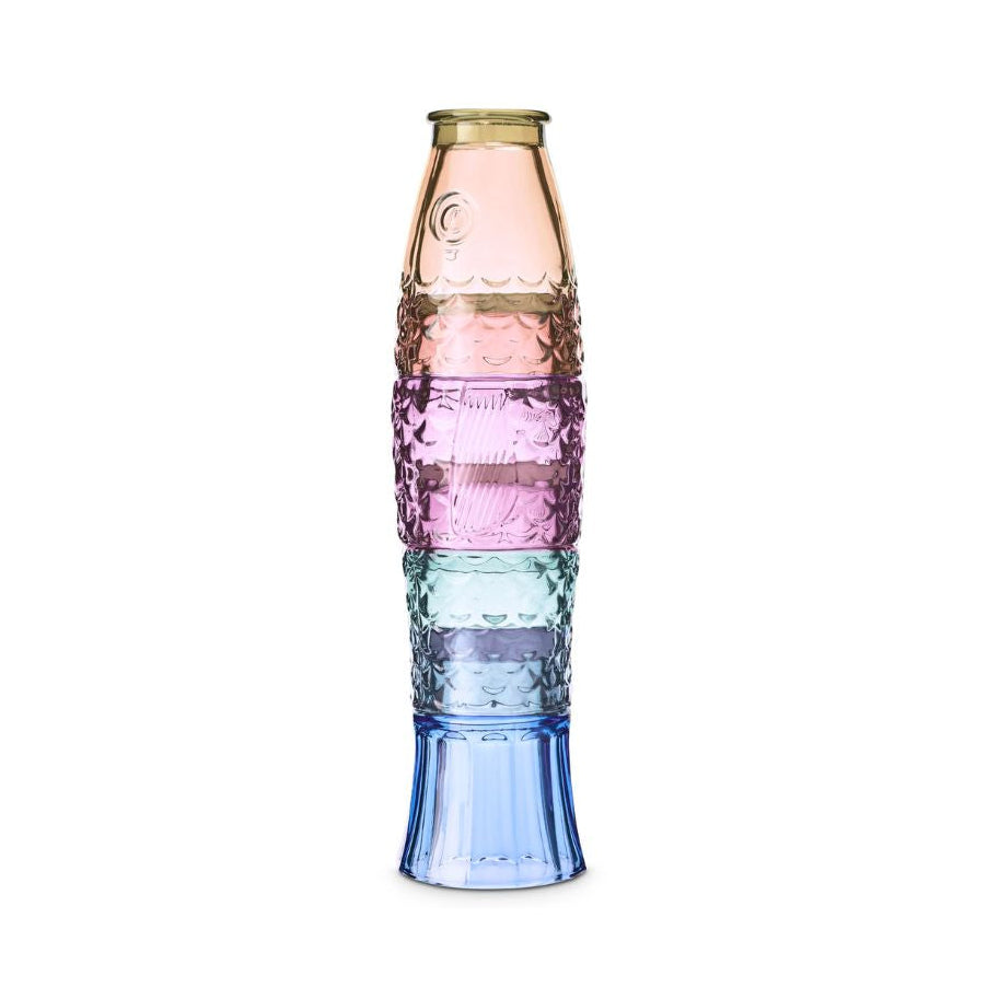 A stack of four textured glass stacking cups in a vertical rainbow gradient, featuring gold, pink, light blue, and dark blue sections, set against a plain white background.