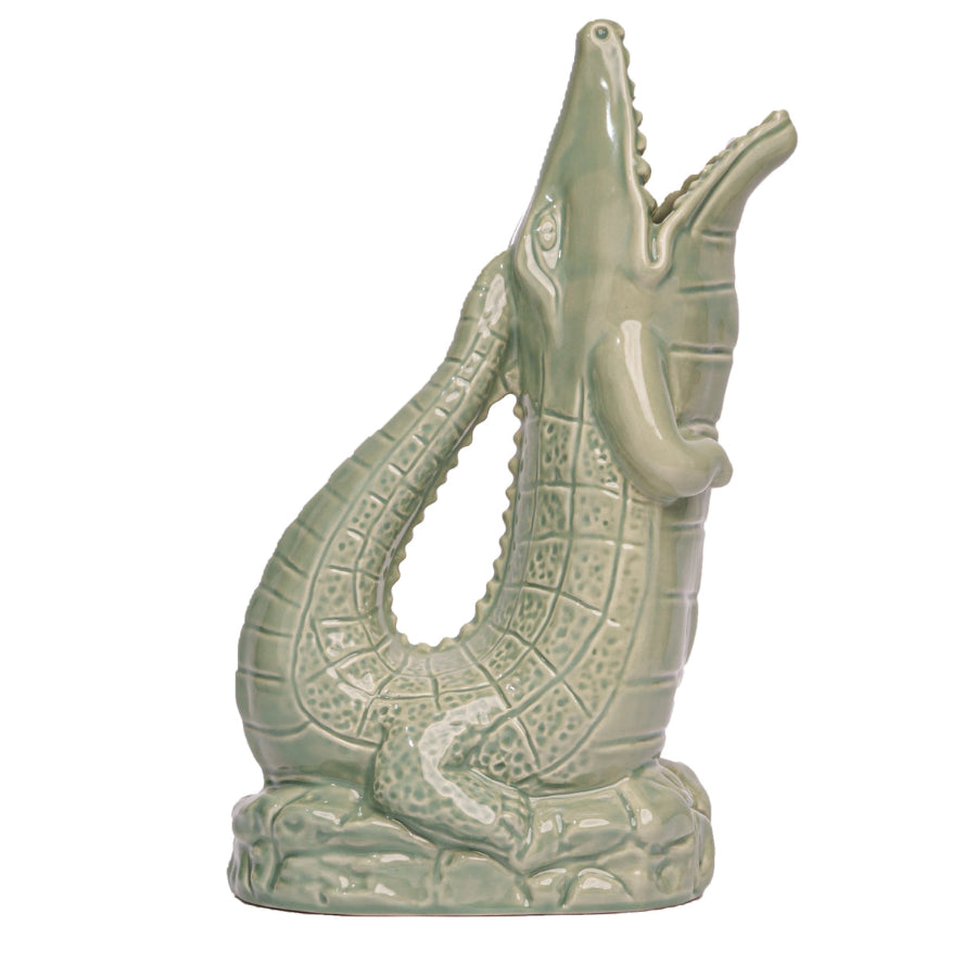 Green ceramic alligator figurine on a white background