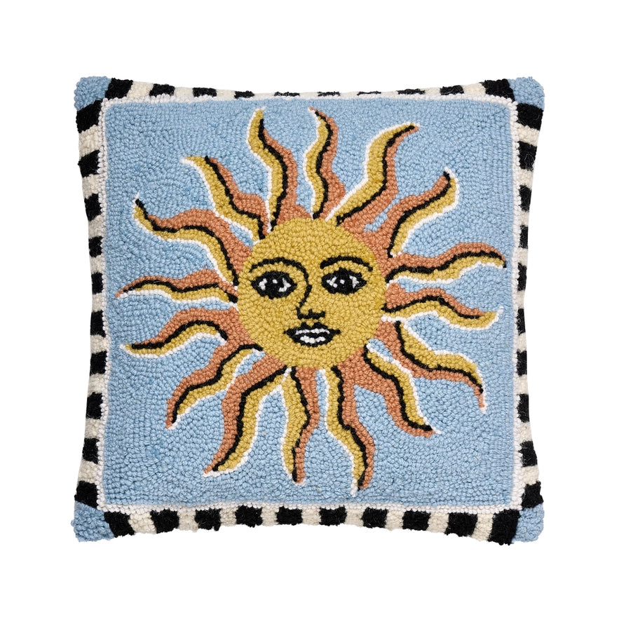 Decorative pillow with a sun design on a light blue background