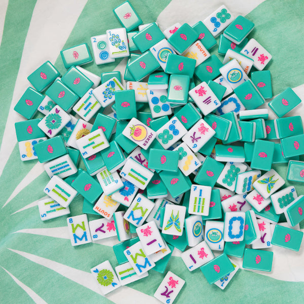 Collection of colorful game tiles on a green surface